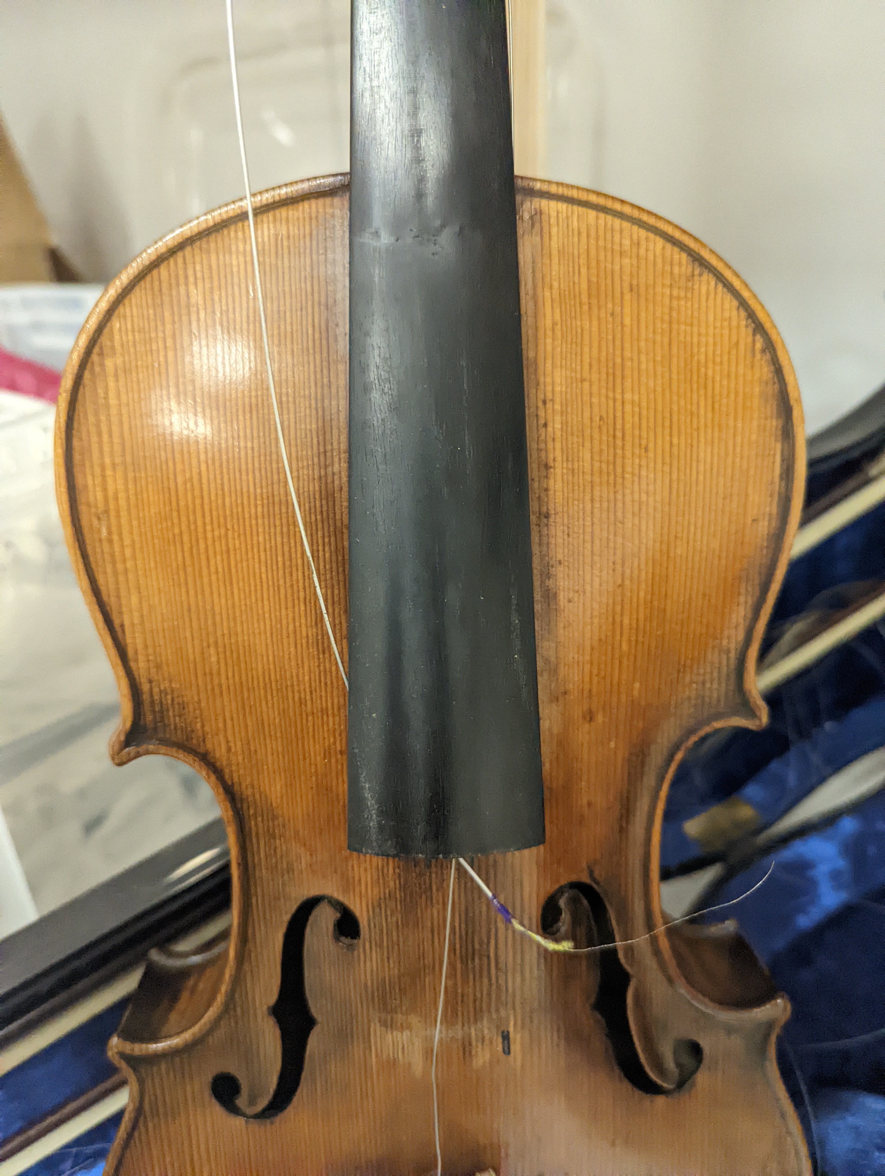 An early 20th century French or English violin with two bows, each stamped